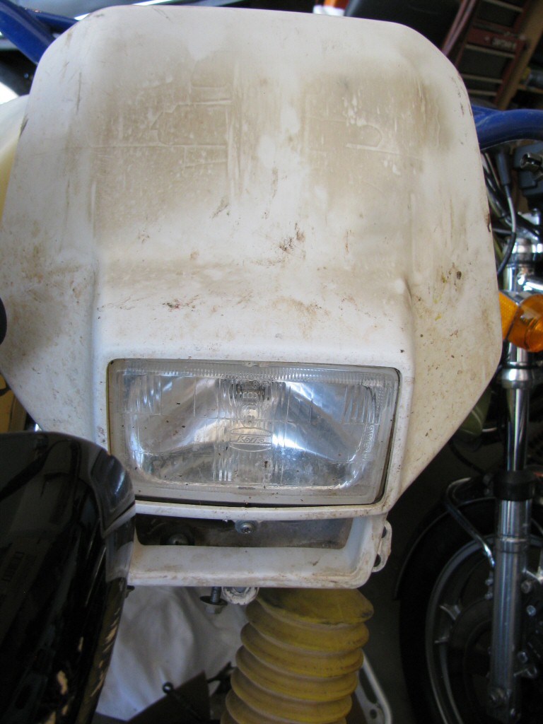 Headlight and shroud from a 1993 Suzuki DR350 dirt model.