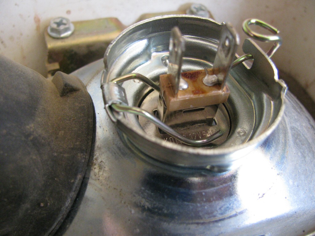 Headlight and shroud from a 1993 Suzuki DR350 dirt model.