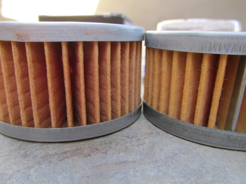Tusk filter on left: measures 33.94 mm in overall height; Suzuki filter on right: measures 32.34 mm in overall height. In my experience, the greater overall height of the Tusk filter directly causes the small O-ring to be displaced, greatly compromising the seal.