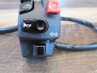 Domino left handlebar switch: horn and turn signal switches.