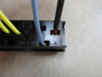 Light blue wire is inserted into the L.E. hole.