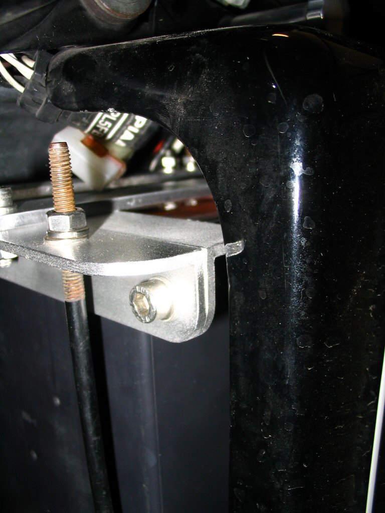 A close-up view of the side cover clearing the battery hold down bracket. Applicable to Moto Guzzi V700, V7 Special, Ambassador, 850 GT, 850 GT California, Eldorado, and 850 California Police motorcycles.