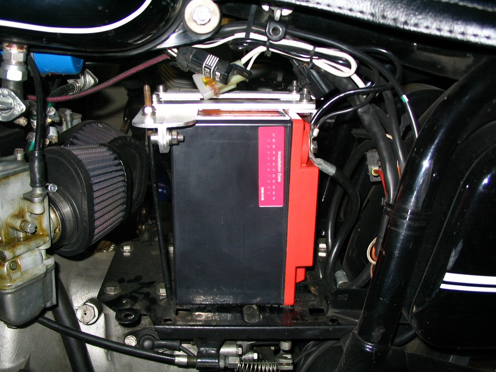 View of the left side of the battery installed with the bracket in place. Applicable to Moto Guzzi V700, V7 Special, Ambassador, 850 GT, 850 GT California, Eldorado, and 850 California Police motorcycles.