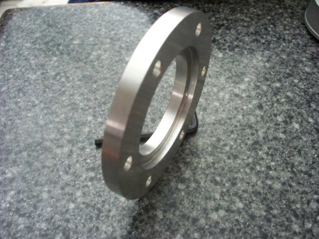 Disc brake spacer as used to fit a disc brake to drum brake Moto Guzzi V700, V7 Special, Ambassador, 850 GT, 850 GT California, Eldorado, and 850 California Police motorcycles.Spacer made by Joe Kenny.