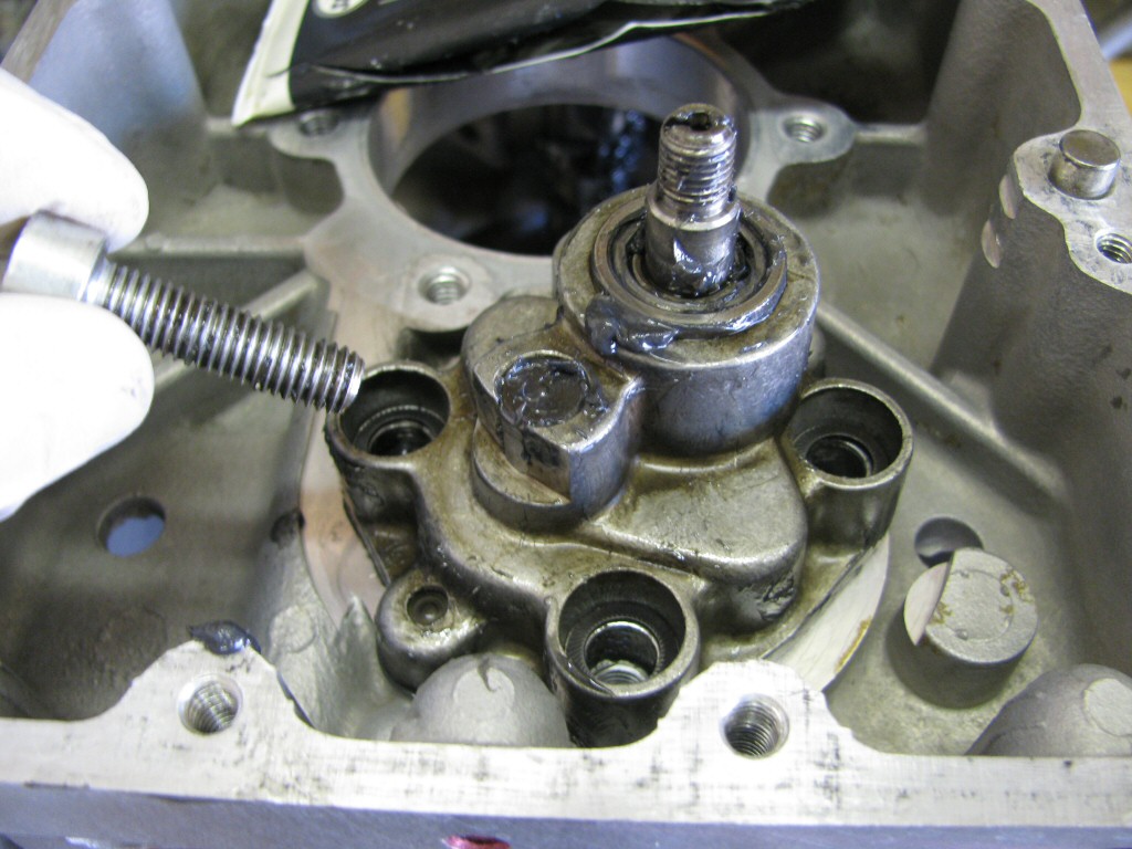 The oil pump gets installed with a good coating of assembly lube and new Schnorr washers on the bolts.