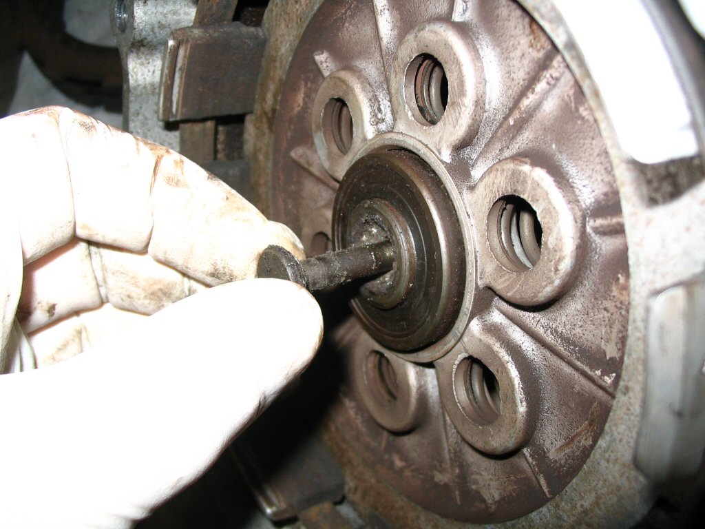 And withdraw the clutch throw out bearing pull rod from the front of the gearbox.