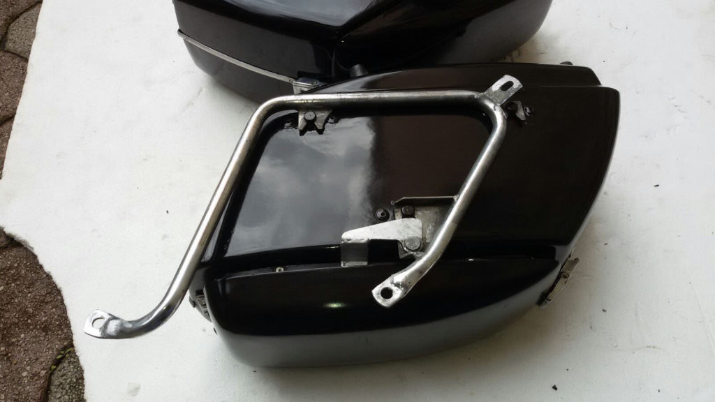 Original Moto Guzzi saddlebags that have had the handles removed from the lid (smaller).