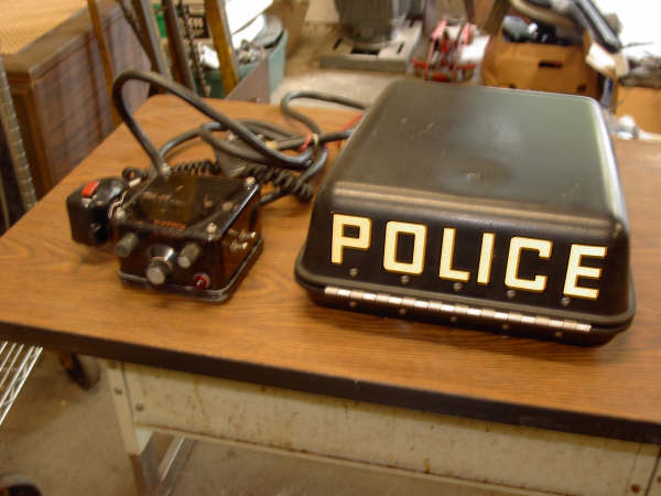 MCR-100 head unit, microphone, cables, and fiberglass box. The police marking has to be removed or covered up. I've heard of some people using the marking POLITE but I think that's risky.