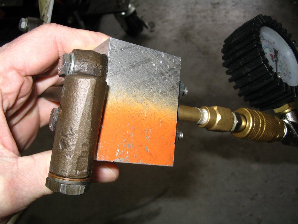 Pressure tester for an oil pressure relief valve.