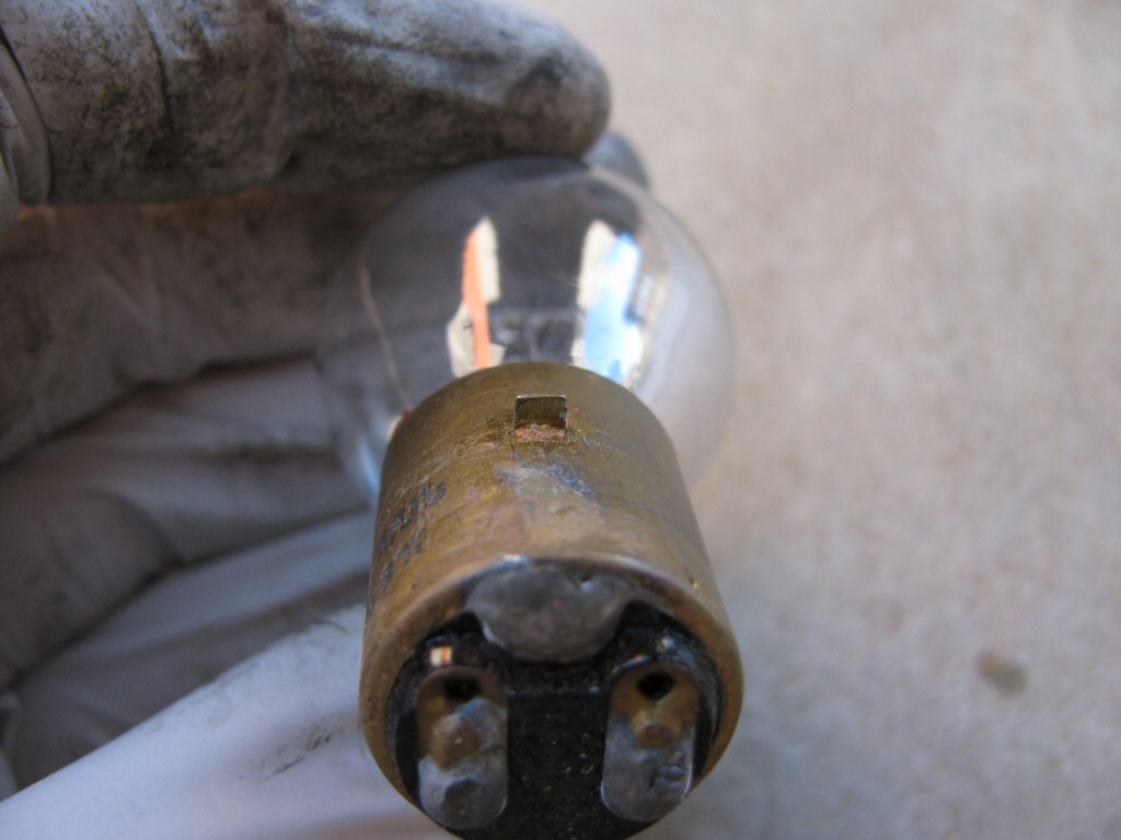 Narrow tang on the headlight bulb as fit to a Moto Guzzi Astore.