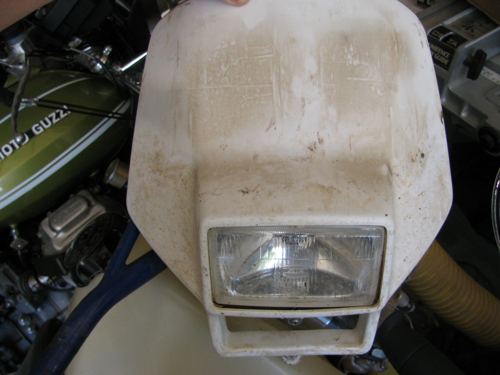 Headlight and shroud from a 1993 Suzuki DR350 dirt model.