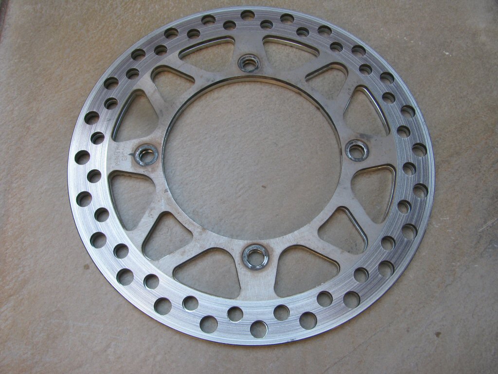 Original front disc placed directly on top of the replacement front disc.