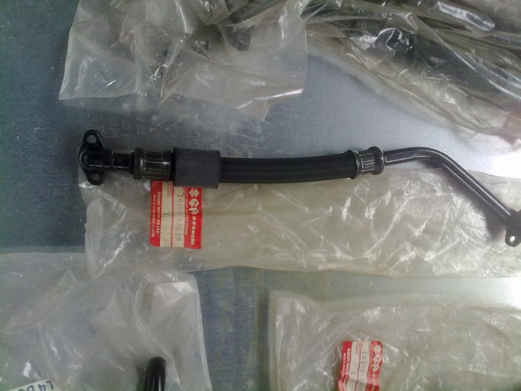 Original oil cooler parts for a Suzuki DR350.