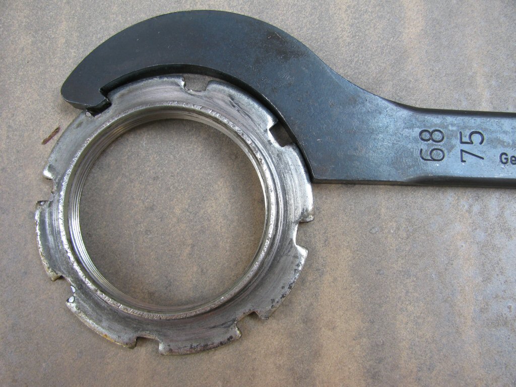 Fixed hook spanner wrench to adjust the shock preload on a Suzuki DR350.