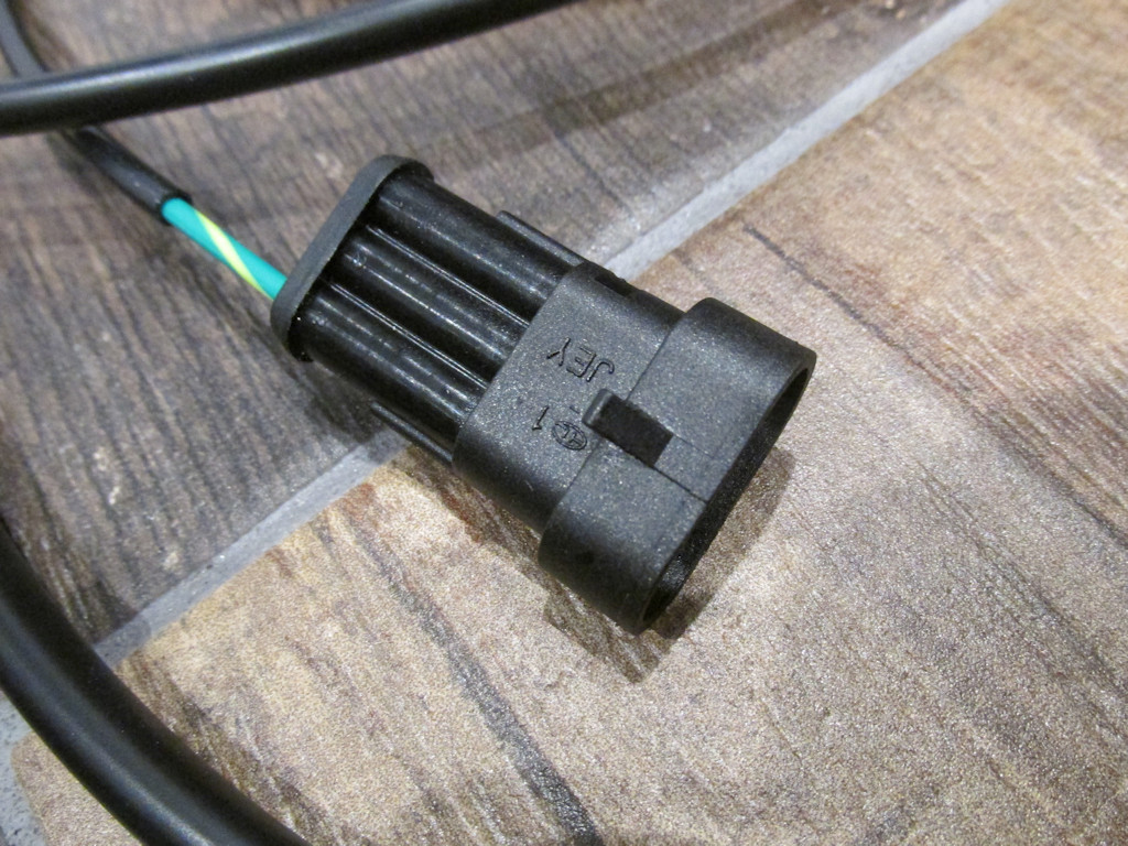 Connection to the three pin OEM Moto Guzzi wiring harness connector located under the seat.