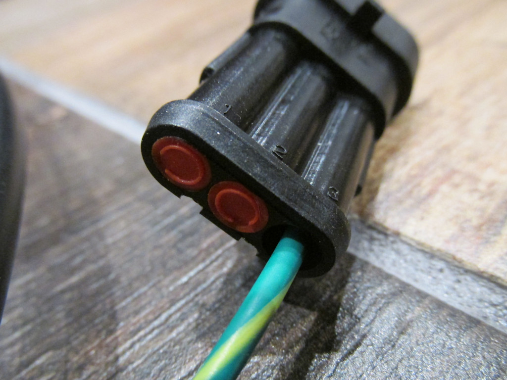 Connection to the three pin OEM Moto Guzzi wiring harness connector located under the seat.