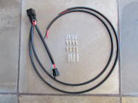 Plug-in-ready, relay-equipped harness for adding auxiliary lights for non-OEM LED lights on the Moto Guzzi V85 TT.