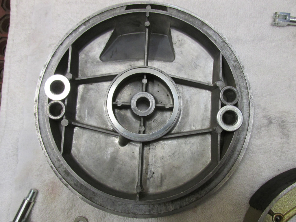 The inside of the brake plate with the large flat washers positioned where the rotating pivots will be inserted.