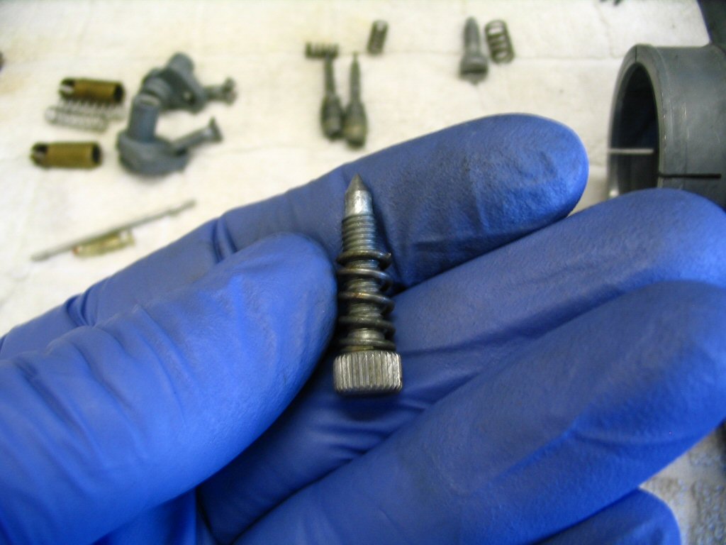 Place the spring on the idle speed screw.