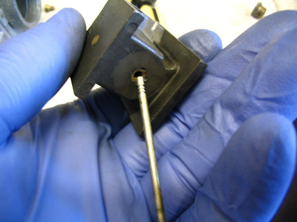 Insert the top of the tapered needle into the bottom of the slide and push it through. I do it this way so that I avoid any potential damage to the tapered needle.