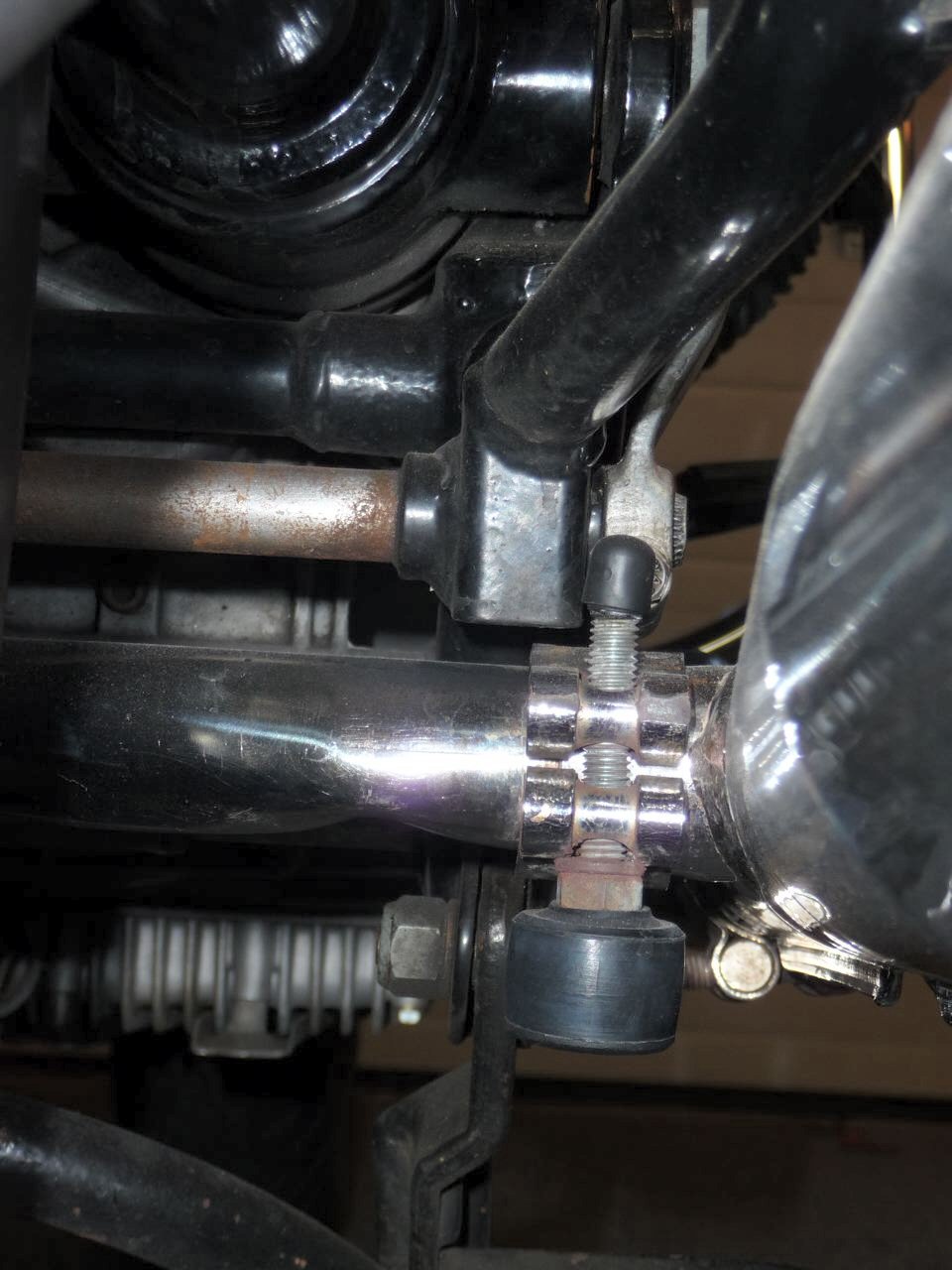 Using the clamp on the crossover pipe as a center stand stop tab for Moto Guzzi V700, V7 Special, Ambassador, 850 GT, 850 GT California, Eldorado, and 850 California Police models.