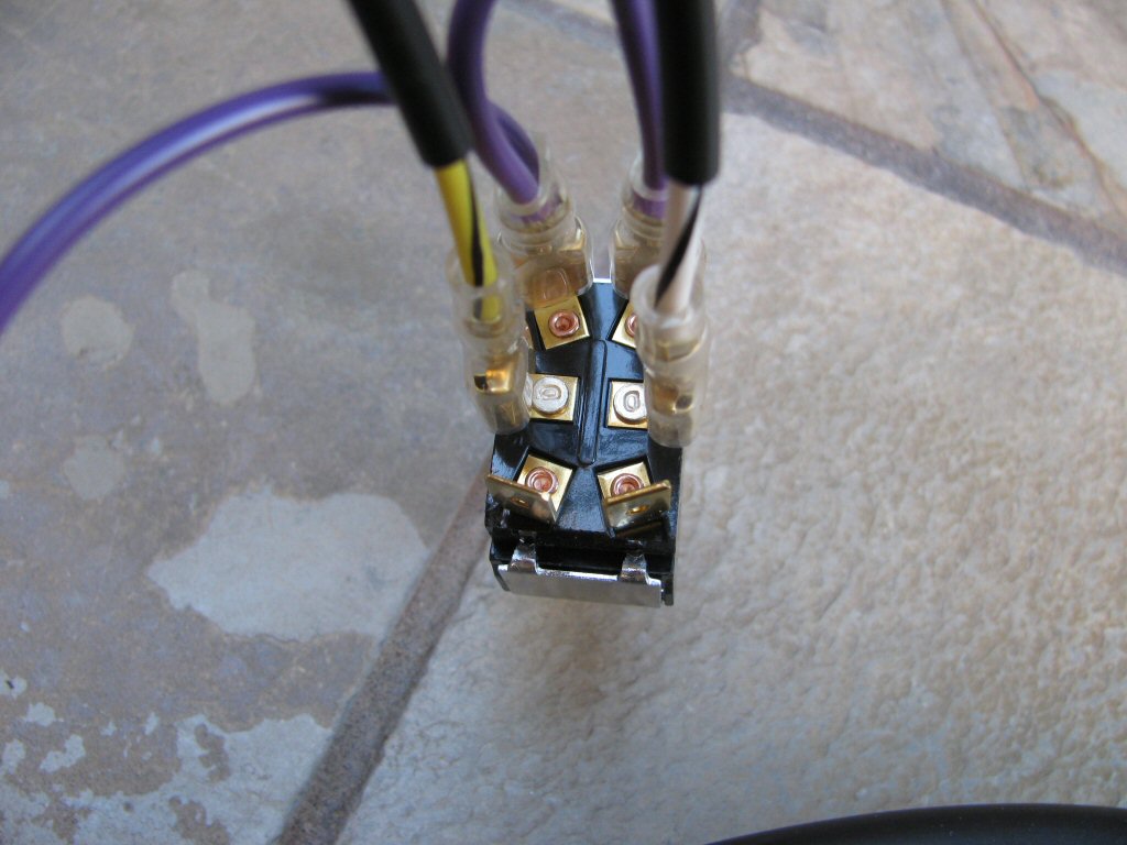 The white/black and yellow/black wires from the toggle switch to 3 connection female spade connectors sub-harness are connected to the middle terminals on the toggle switch.