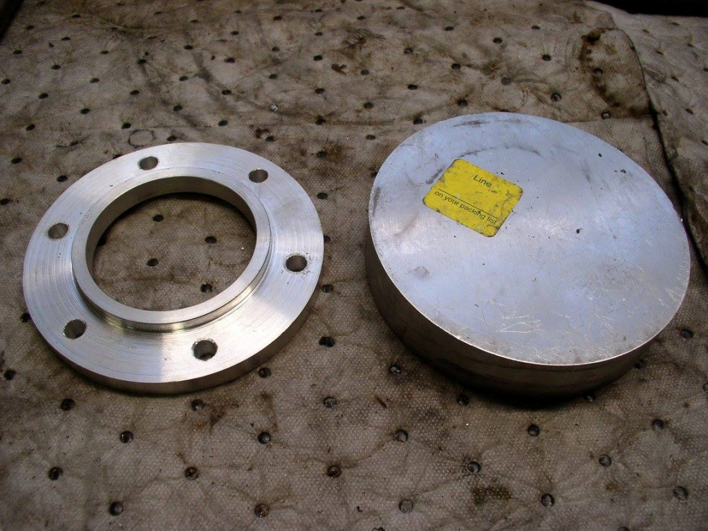 Disc spacers. I used the dimensions provided by Steve Odell to machine my own 10 mm thick disc spacers. Only USD $36.00 in material, but seven hours of my time turning them out on my small, antique lathe. Finished spacer on left, 5 inch diameter × 1 inch thick chunk of 6061 aluminum I started with on the right.