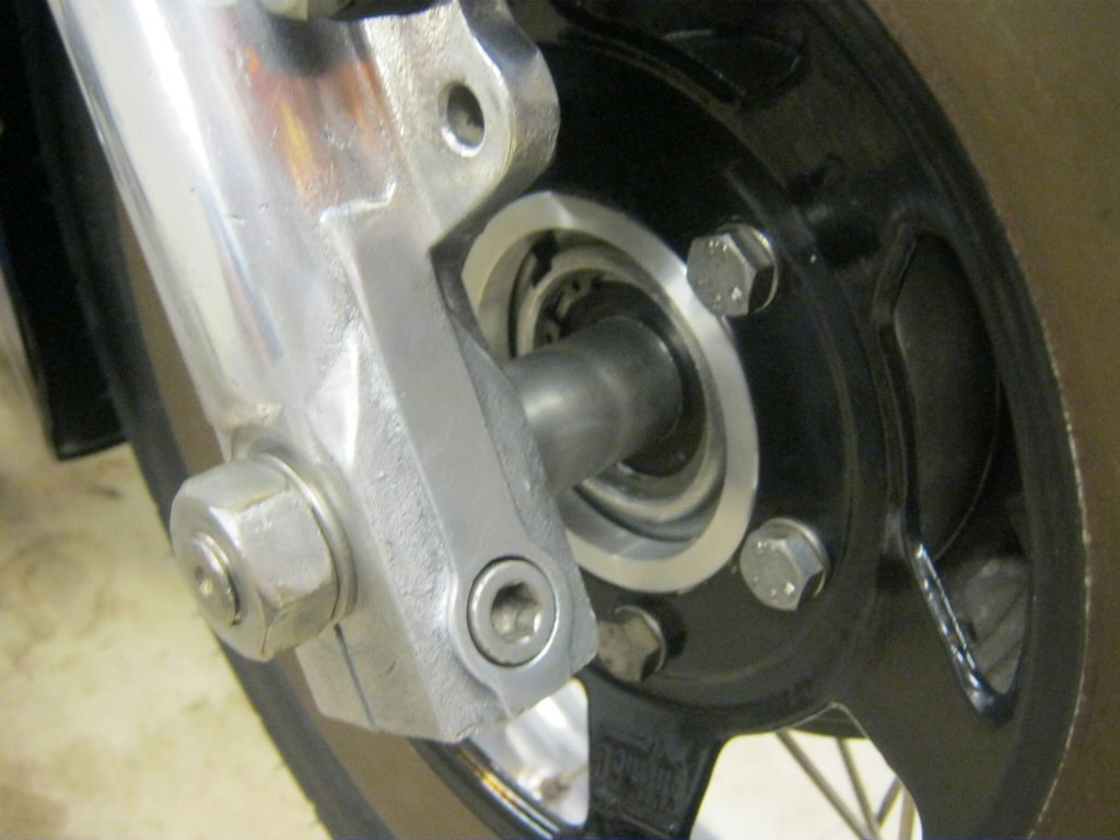Disc brake spacer as used to fit a disc brake to drum brake Moto Guzzi V700, V7 Special, Ambassador, 850 GT, 850 GT California, Eldorado, and 850 California Police motorcycles.Spacer made by Steve Odell.