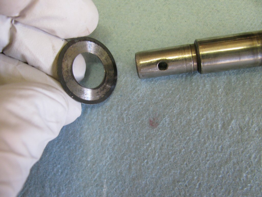 Place the thin flat washer onto the rotating shaft.
