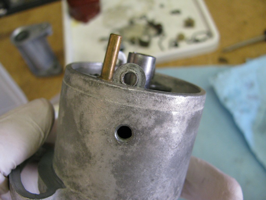 The single threaded hole lines up with the single hole in the distributor body.