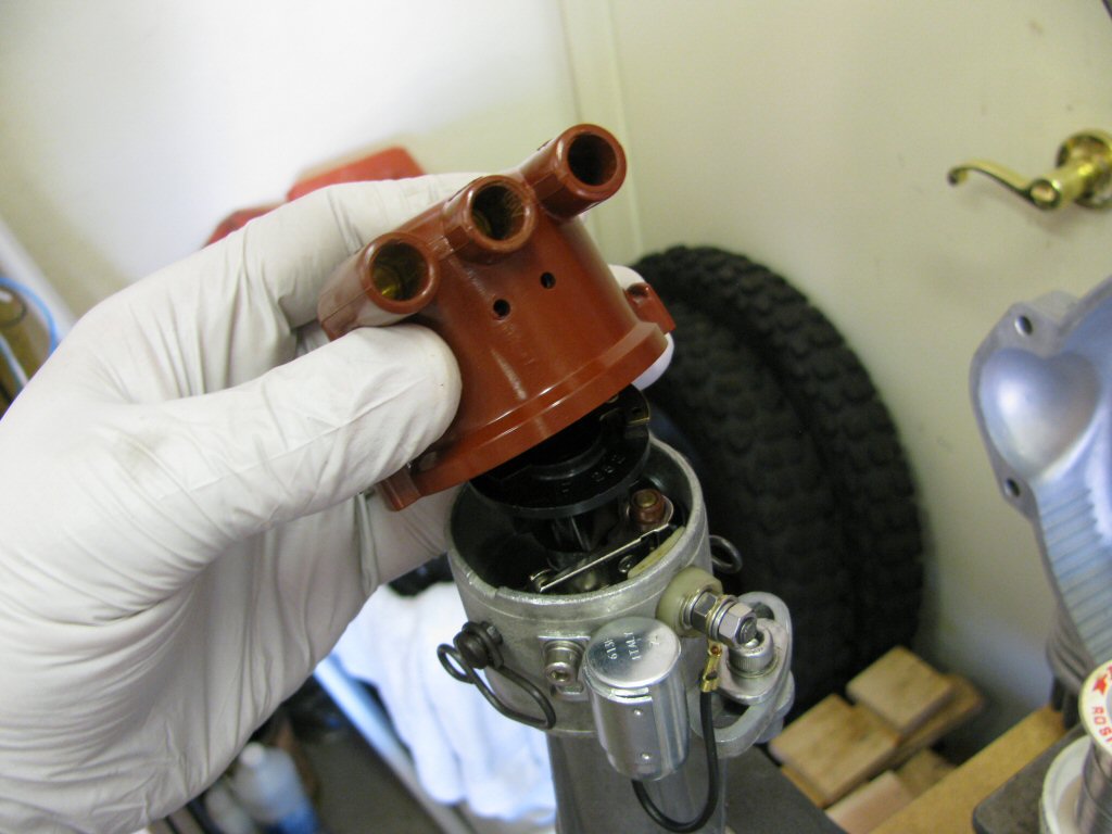 Fit the distributor cap. Note that the bottom of the distributor cap is notched to fit into a corresponding notch in the body of the distributor.