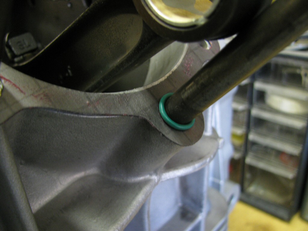 An O-ring is placed on the bottom-most stud (the 6 o'clock stud).