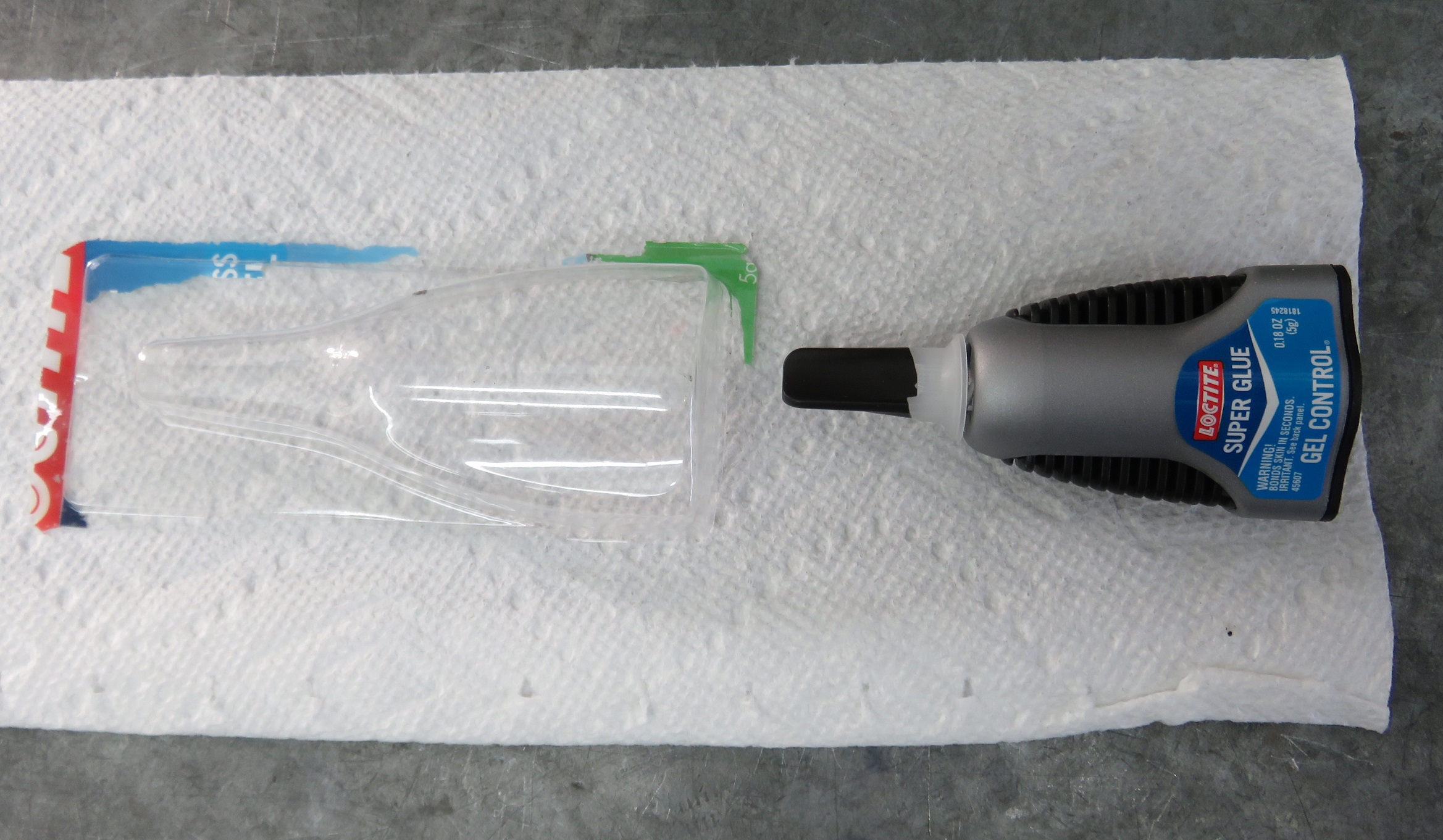A fix uses a thin cut of plastic packing from a super-glue package. It's flexible and strong.