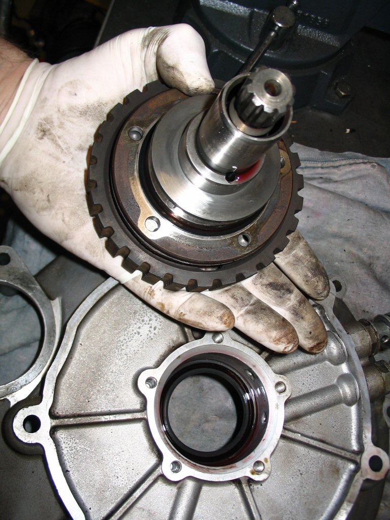 Remove each of the 5 bolts and withdraw the assembly. The complete clutch input hub assembly should slide right out of the converter cover.