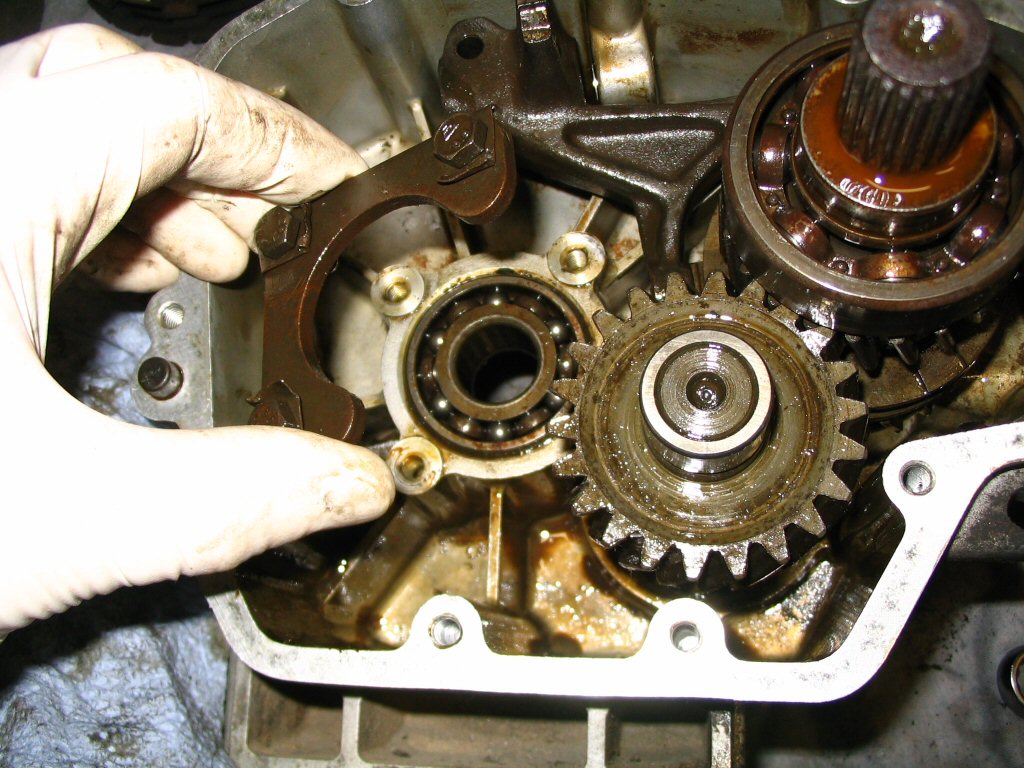 Remove the three bolts and the bearing retainer.