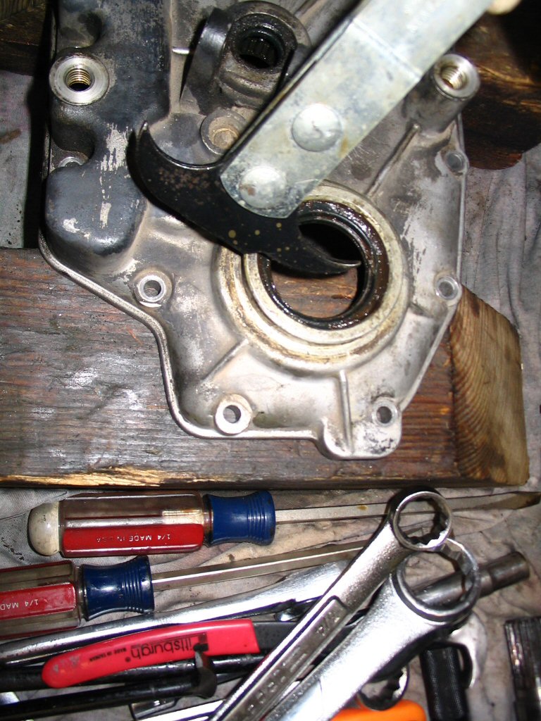 Use a seal puller to remove the output shaft (layshaft) seal from the rear cover.