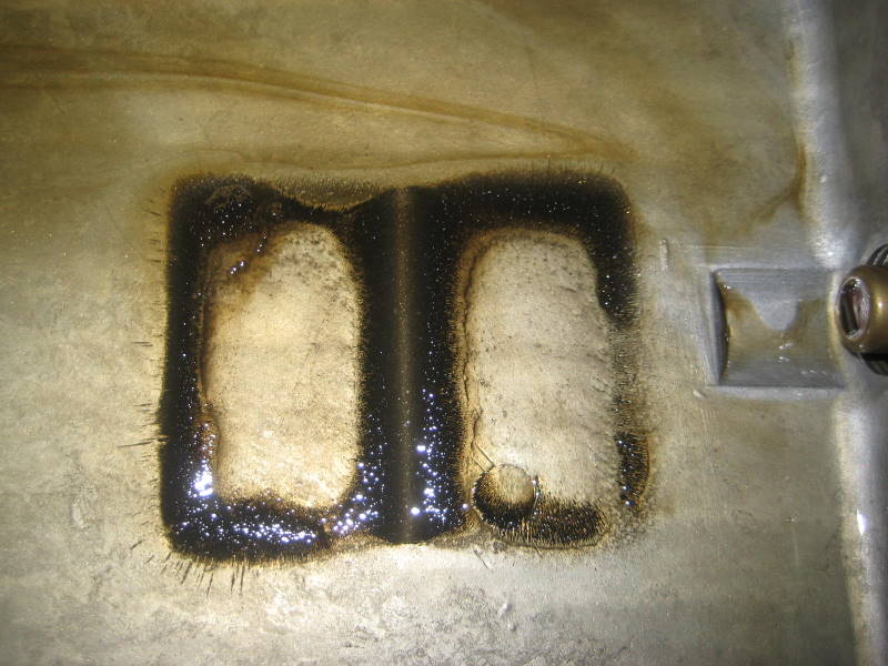 After 2,200 milesOver the course of the next 2,200 miles I drained the oil twice without dropping the pan. When changing oil never remove the magnet from the pan unless you are going to drop the pan. At the third oil change I dropped the pan. This is 2,200 miles worth of sludge.