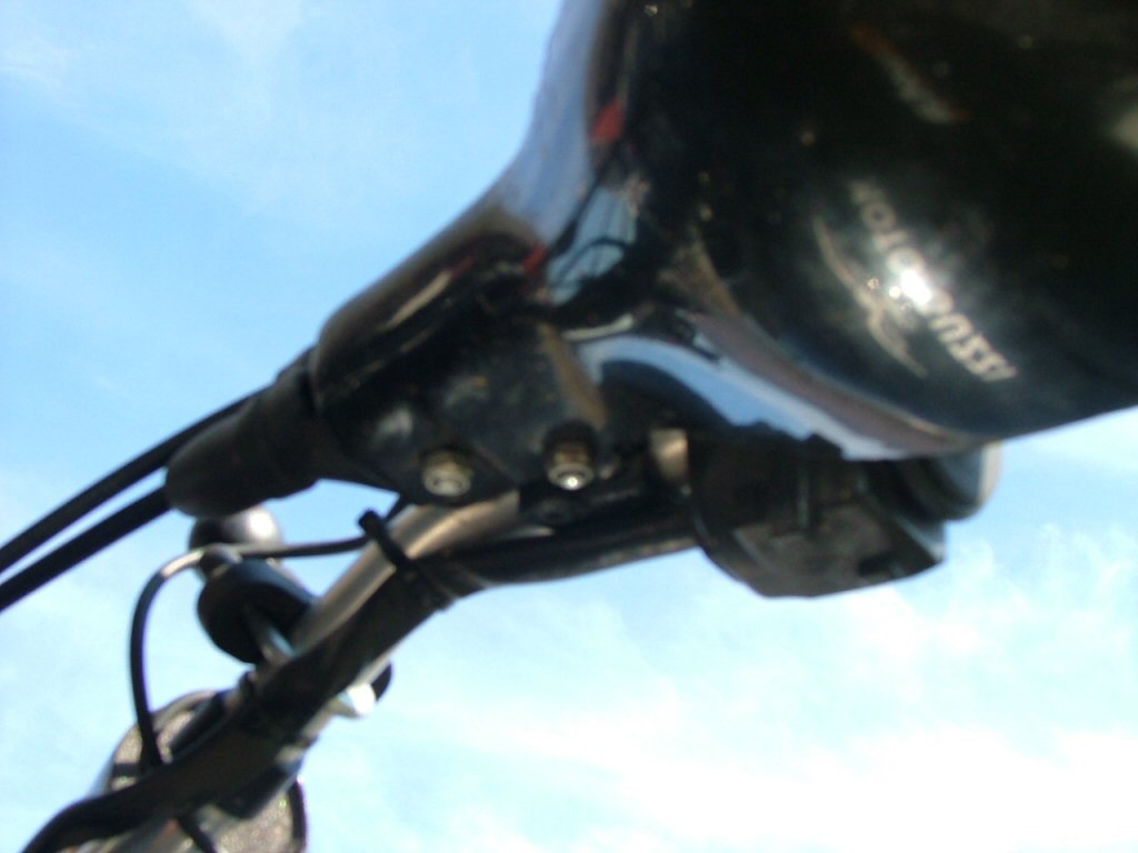 Underside of left guard showing two nylock nuts on pivot bolt and stabilizer bolt. Mounting Triumph Tiger hand guards on a Moto Guzzi Quota 1100 ES.