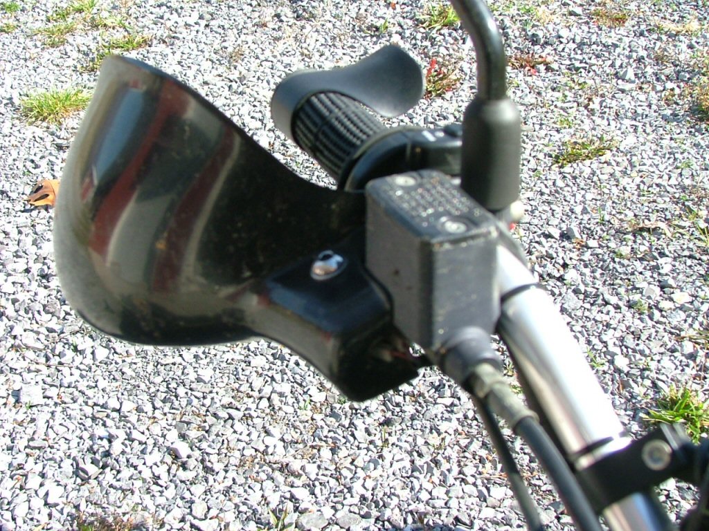 Right guard just needs minor sculpting of master cylinder cutout. Close fit means no wobble. Also create a cutout for the brake switch wires. Bolt longer than stock (from the parts bin). Mounting Triumph Tiger hand guards on a Moto Guzzi Quota 1100 ES.