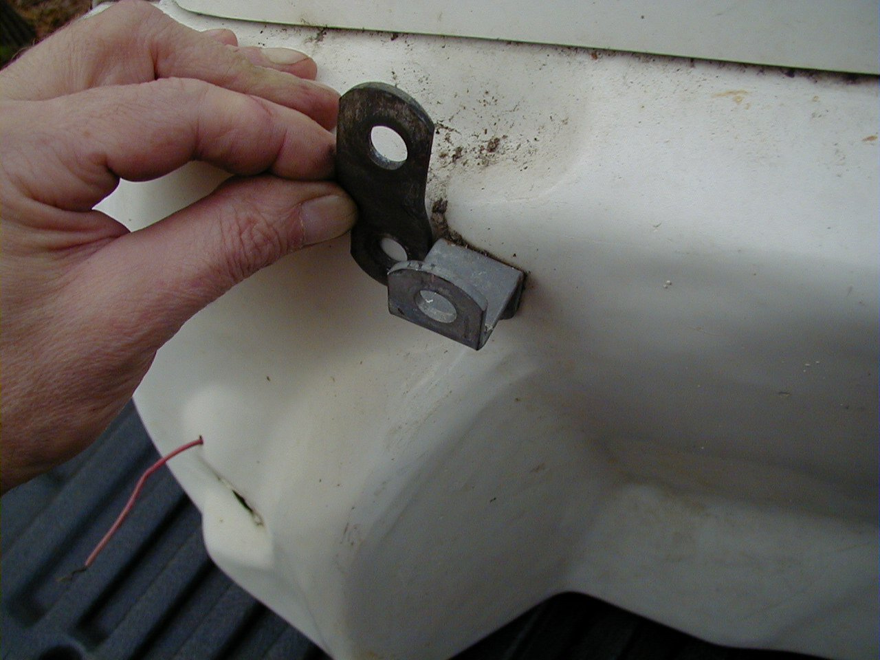 Another view of the upper rear bracket that attaches to an existing hole in the frame. Loop bracket is being held by Charley; Tonti bracket is secured to the saddlebag.