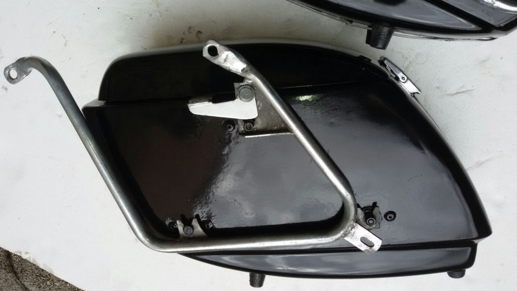 Original Moto Guzzi saddlebags that have had the handles removed from the lid (smaller).