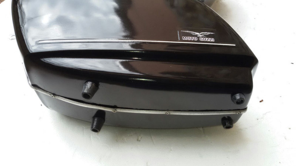 Original Moto Guzzi saddlebags that have had the handles removed from the lid (smaller).