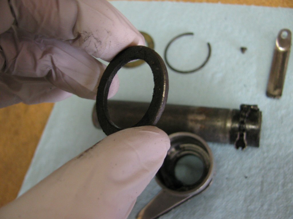 Slide the metal thrust washer off of the tube.