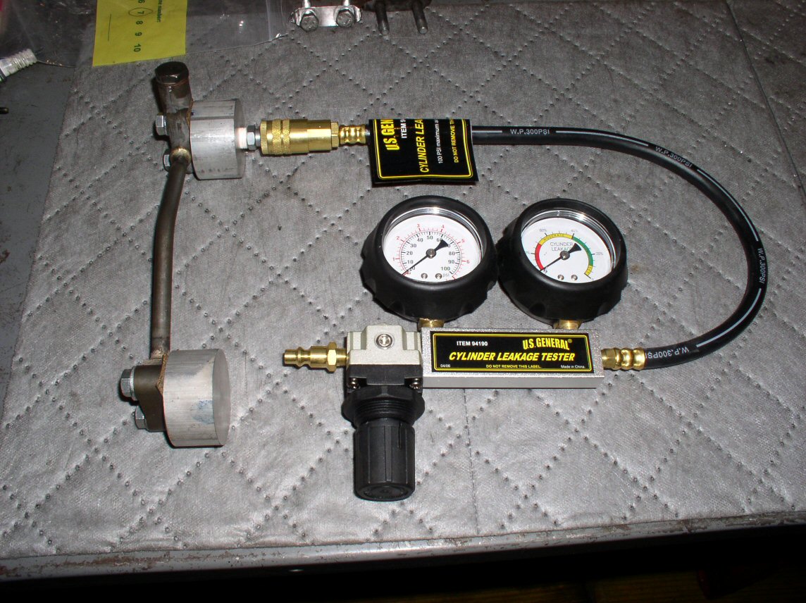 Pressure tester for an oil pressure relief valve. Ready to use. Just hook it to the air supply and dial up the regulator.