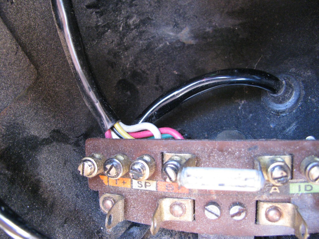 Wiring from the handlebar switch enters the headlight bucket and is soldered to the distribution panel or the key switch panel as fit to a Moto Guzzi Astore.
