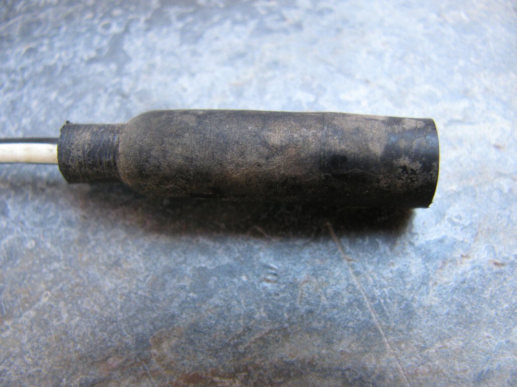 Female bullet terminal with black rubber insulation.