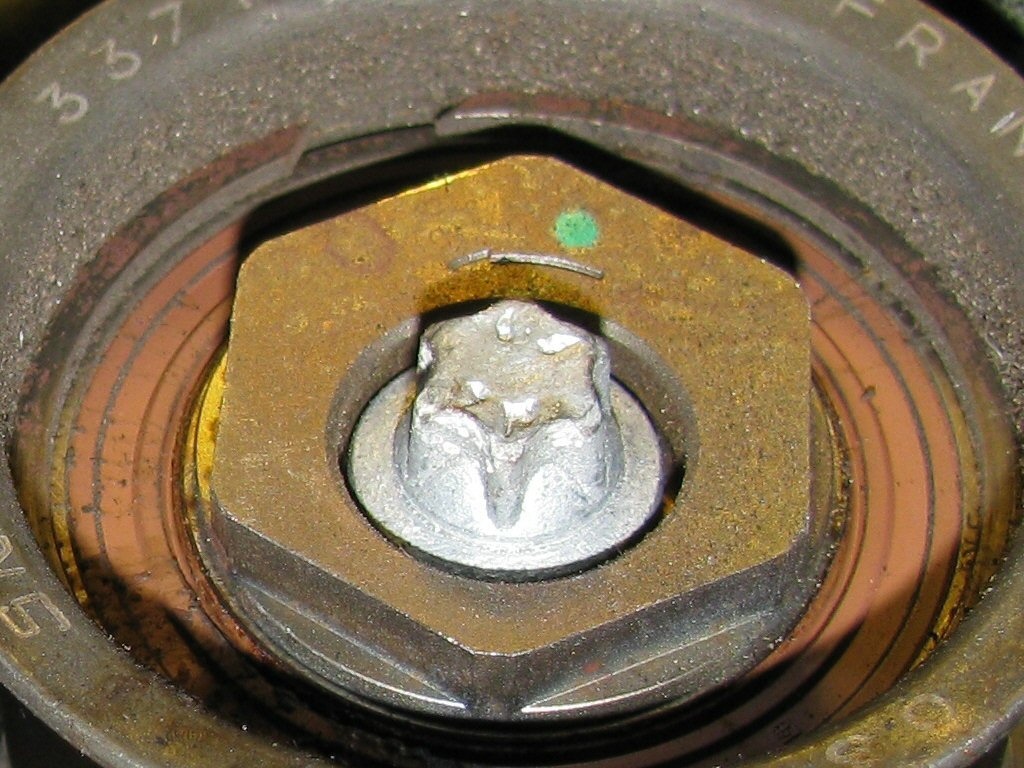 Lower idler pulley. Note the location of the green dot indicating a good initial position of 12 o'clock.