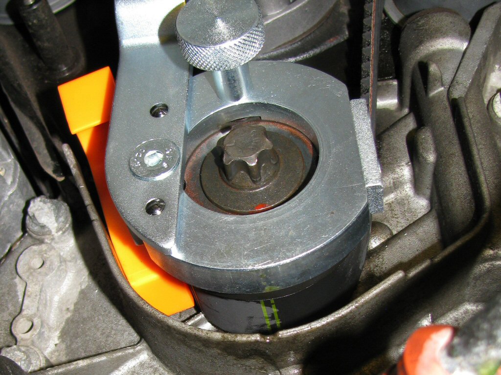 New belt positioned on the crankshaft pulley with the orange plastic wedge in place. Note the double green lines on the belt.
